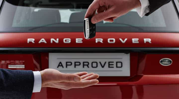 Red Range Rover with approved sign