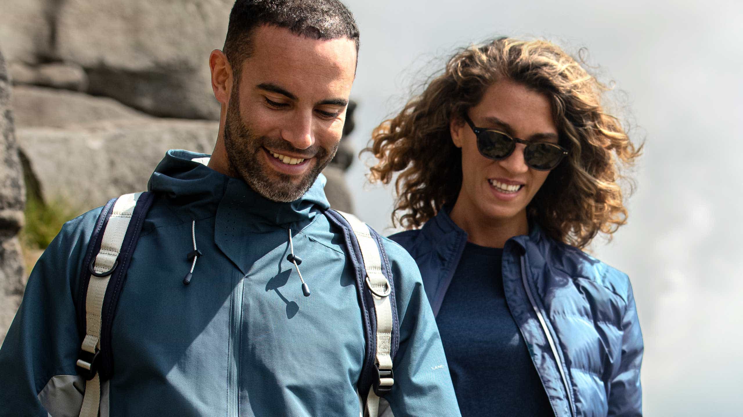 Male and female smiling in jackets