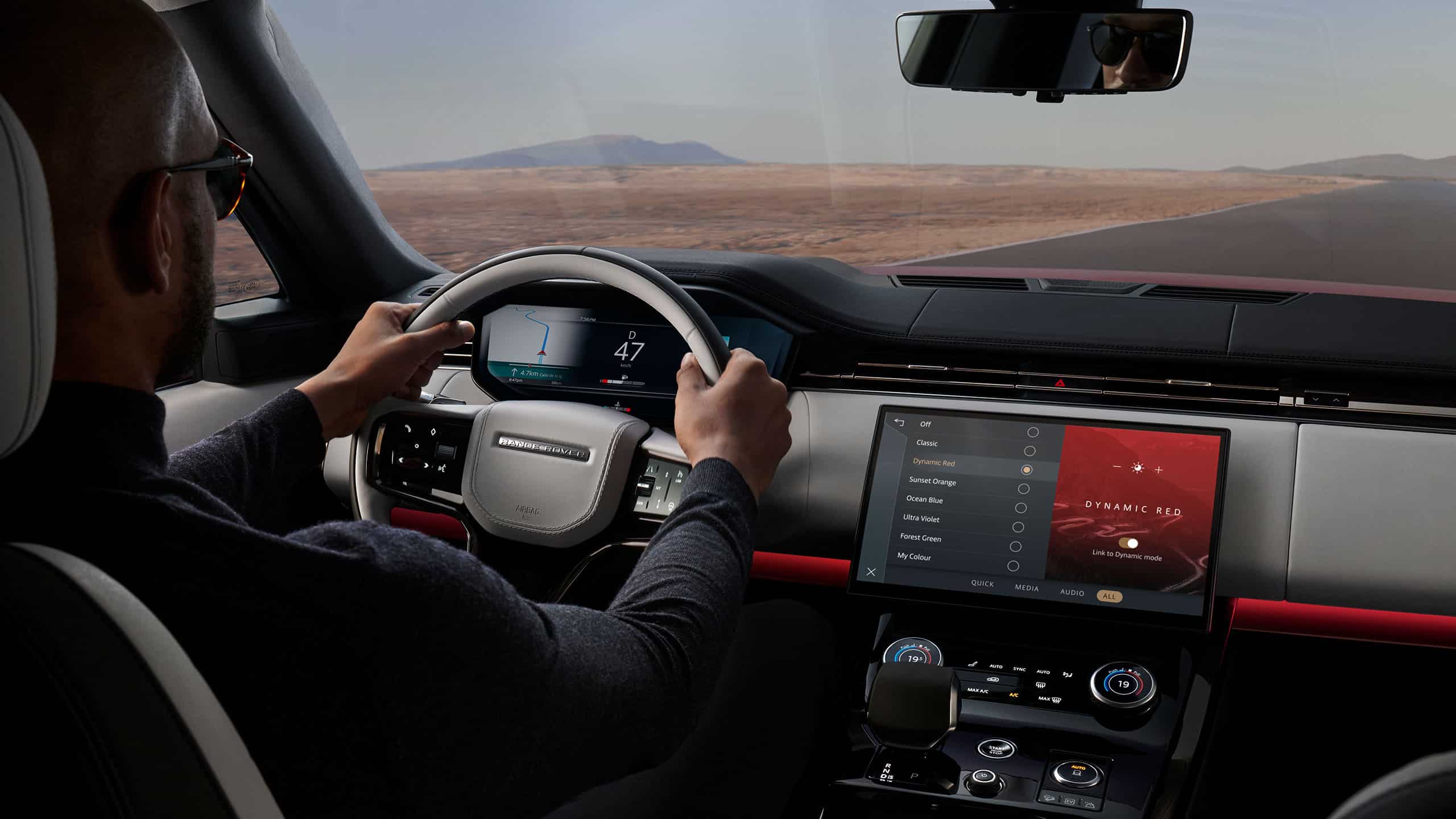Man driving Range Rover Sport on a road