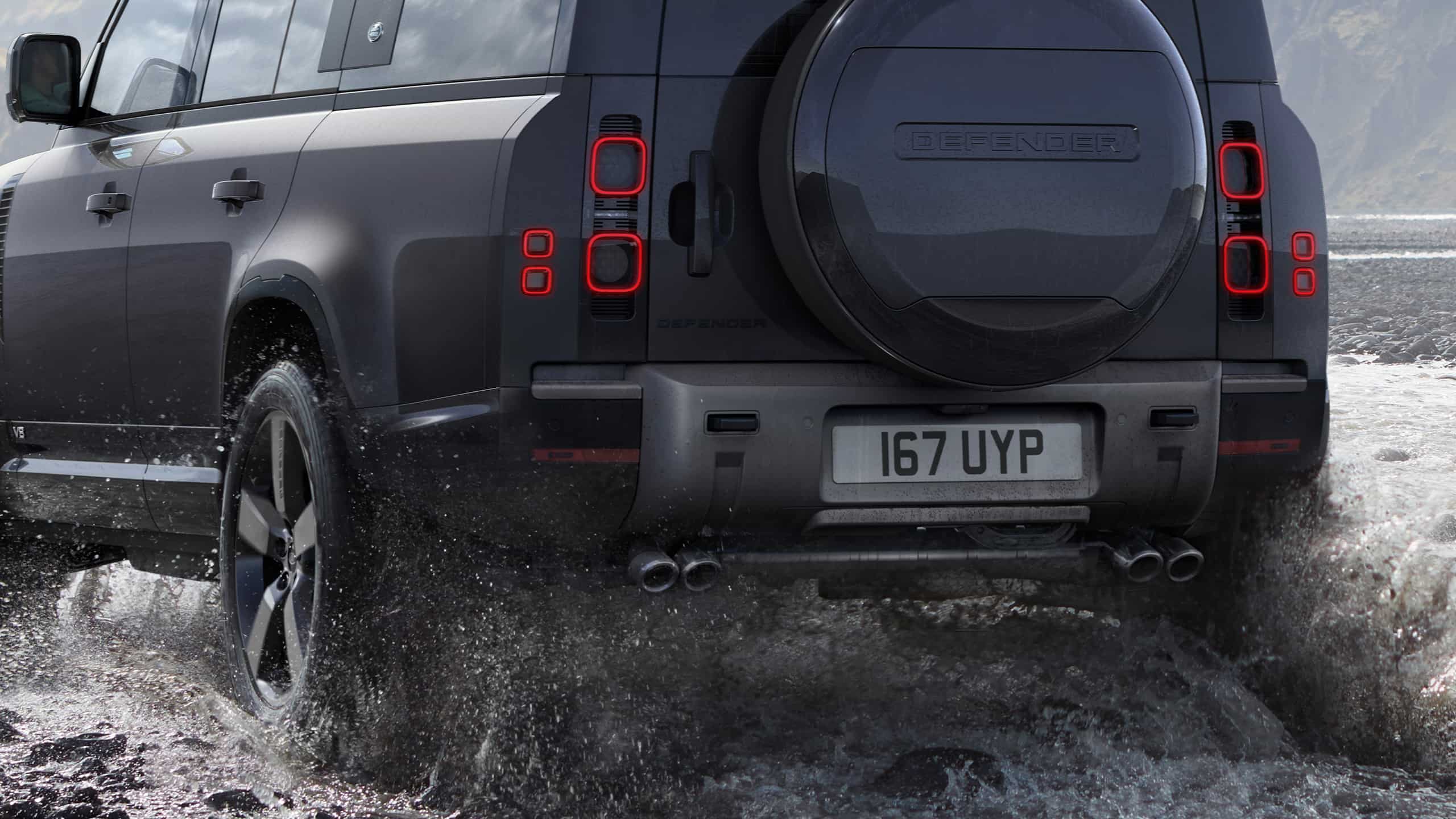 Defender is off roading in the mud of the river